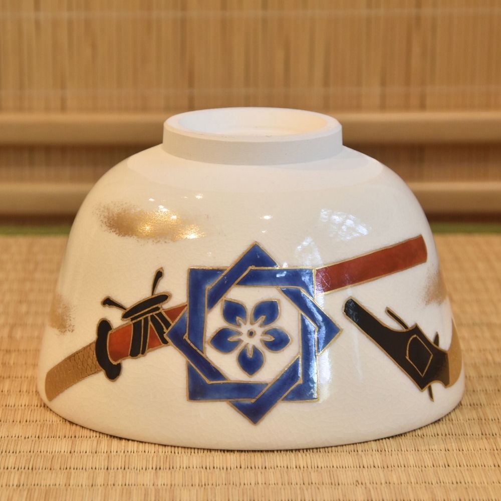 Ceramic bowl with decorative patterns on a woven mat