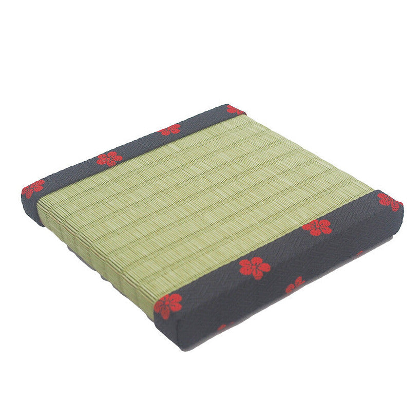 Rectangular mat with green surface and red floral patterns on a white background