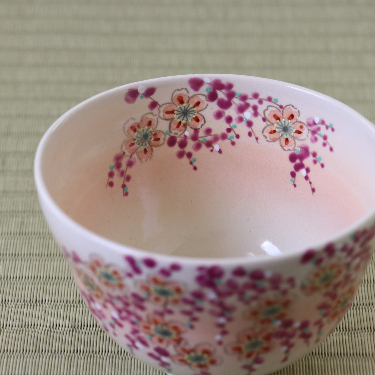 Decorative ceramic bowl with floral patterns on a textured surface