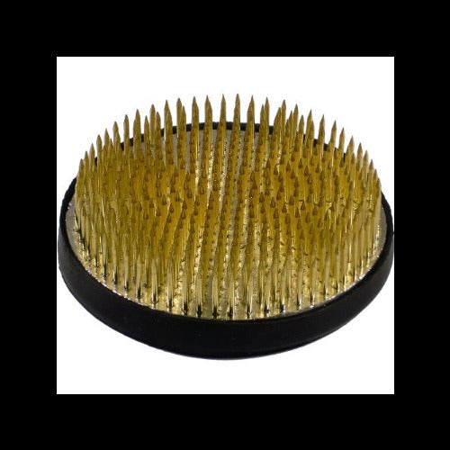 A round grooming brush with dense golden-yellow bristles standing upright on a black circular base, shown against a plain white background.
