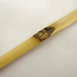 Wooden stick with a small object on a white background