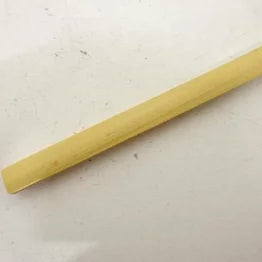 Long, thin wooden stick on a light gray background