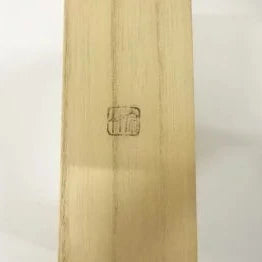 Wooden surface with a logo engraved on it against a white background