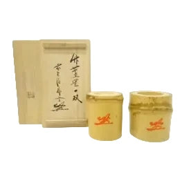 Two bamboo tea canisters with a wooden box on a white background