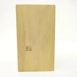 Wooden cutting board with a visible brand logo on a white background