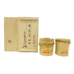 Two wooden containers with red text on a white background