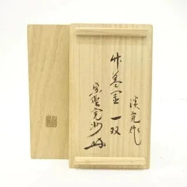 Wooden box with Japanese text and a seal on a white background