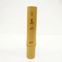 Yellow bamboo incense holder with red text on a white background