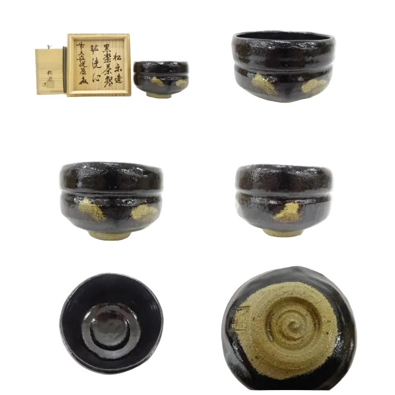 Set of black ceramic bowls with gold accents on a white background