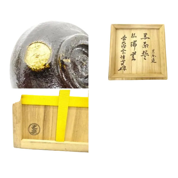 Decorative item with gold coin embedded in stone, framed text, and wooden box with yellow ribbon.