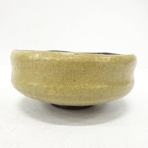 Beige ceramic bowl on a white background