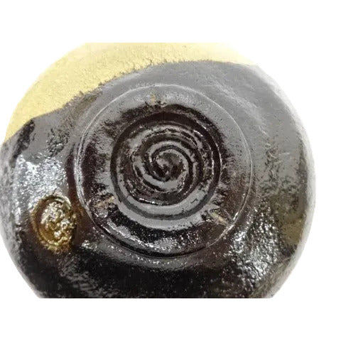 Close-up of a metallic object with a spiral design on a white background