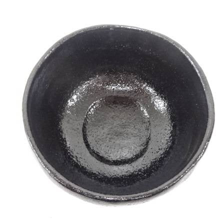 Black ceramic bowl on a white background