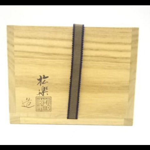 Wooden box with black ribbon and text on a white background