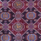 Close-up of a patterned fabric with geometric shapes and animal illustrations on a red background.