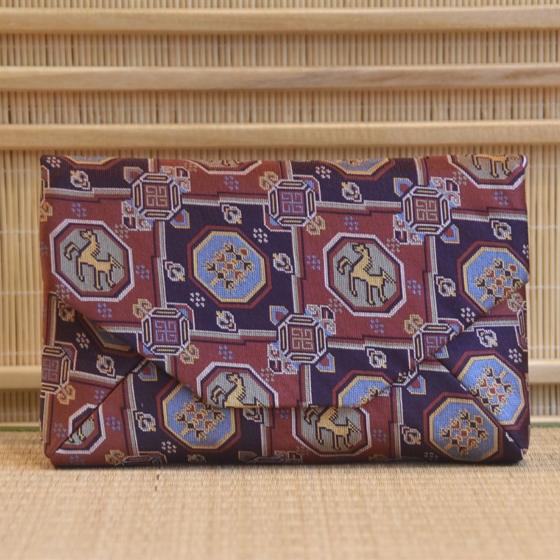 Japanese traditional textile patterned clutch bag on a textured surface