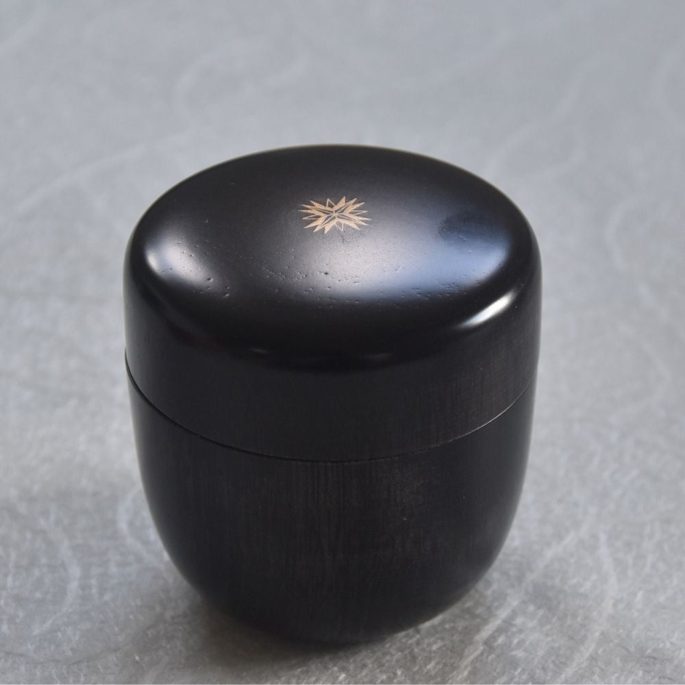 Black container with a gold emblem on a gray background