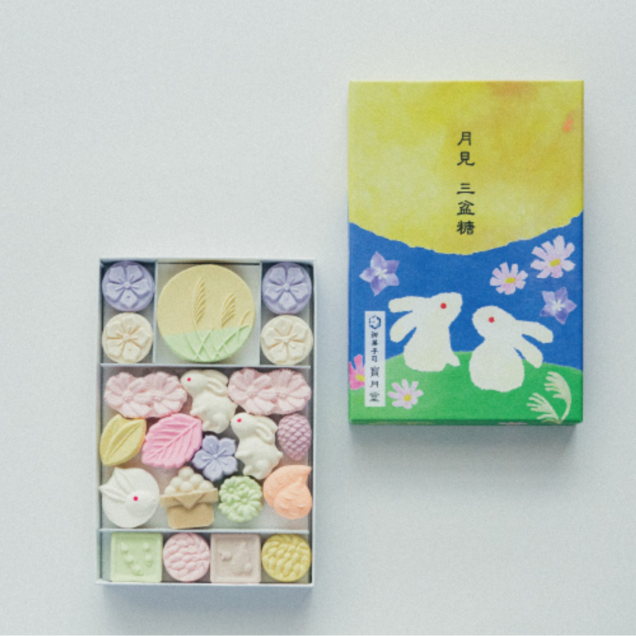 Box of colorful candy with a decorative box on a white background