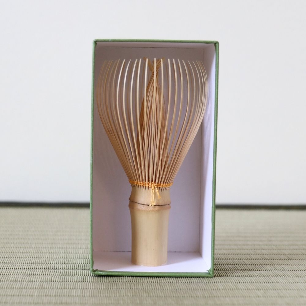 Japanese tea whisk with mustard-colored thread by Kubo Ryosai