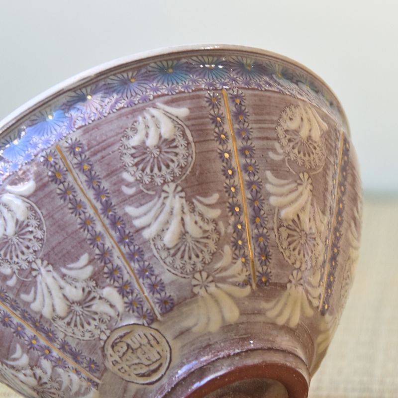 Decorative ceramic bowl with intricate patterns on a neutral background