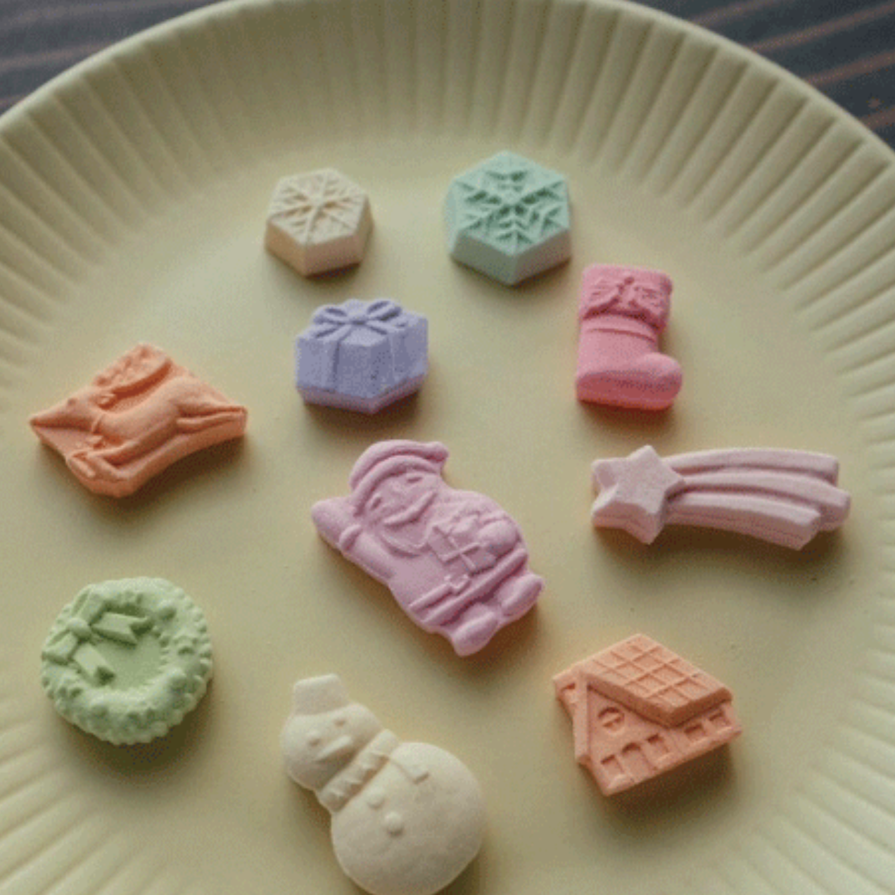 Colorful candy-shaped toys on a beige plate
