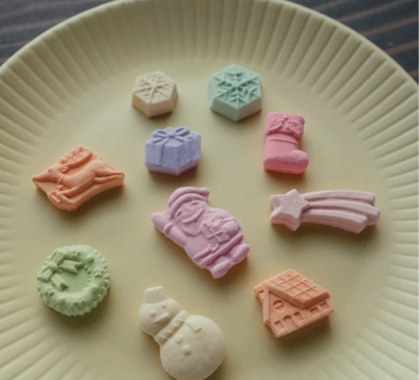 Colorful candy-shaped toys on a beige plate