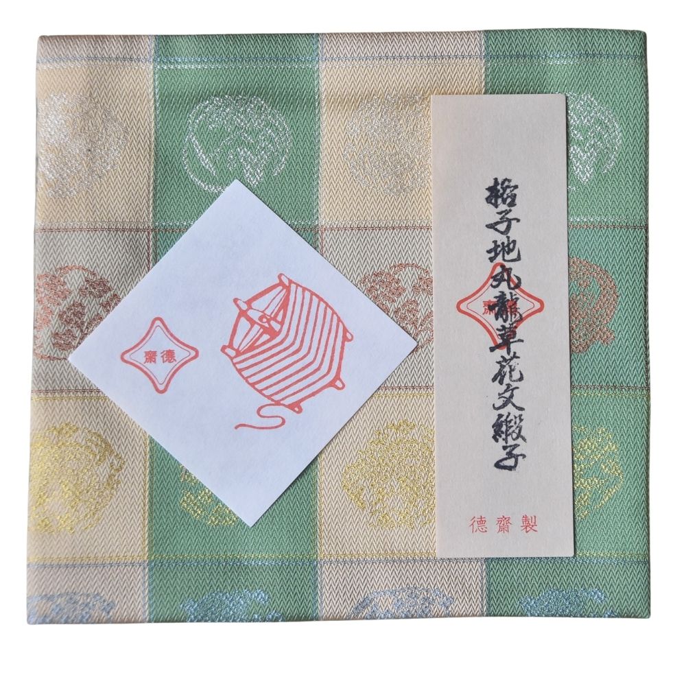 Textile product with a ball of dragon design and text on a checkered background