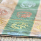 Close-up of a checkered fabric with embroidered patterns