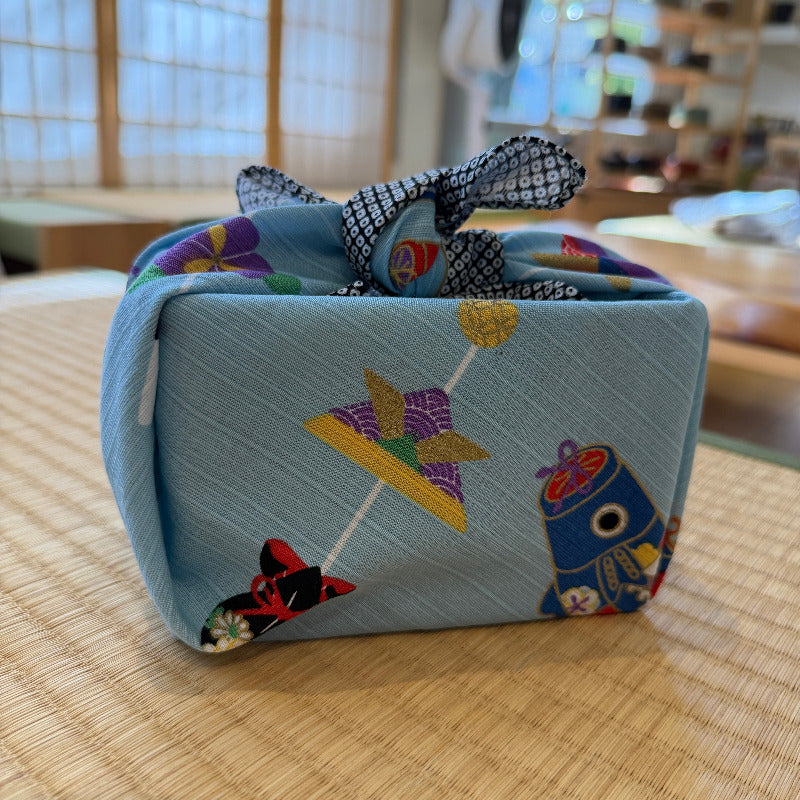 Fabric-wrapped box with colorful designs on a wooden surface