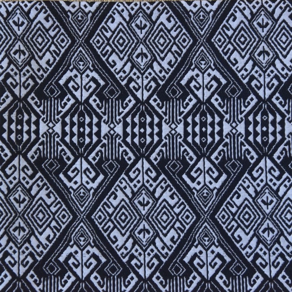 Geometric pattern with black and white diamonds on a blue background