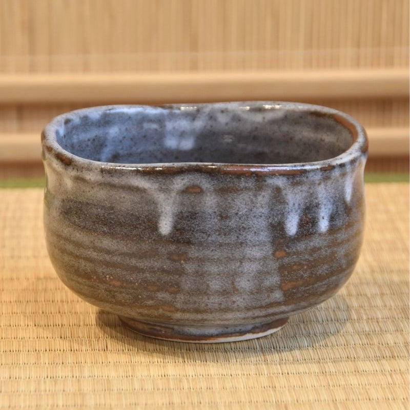 A matcha bowl with gray glaze dripping down.