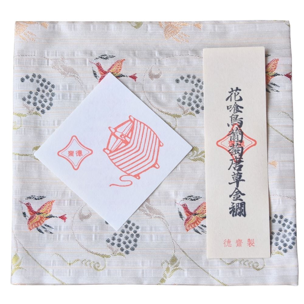 Product packaging with a label and a small card on a decorative background