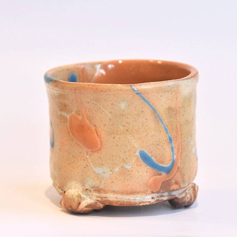 Ceramic cup with abstract designs on a white background