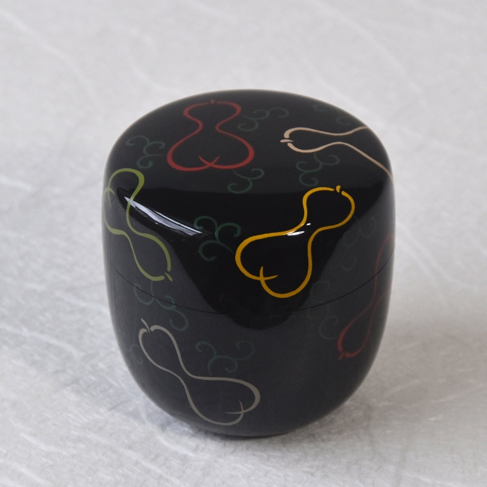 A traditional Yamanaka Lacquerware natsume container with a 'Roppyo' design, featuring six stylized gourds in multicolor on a black background.