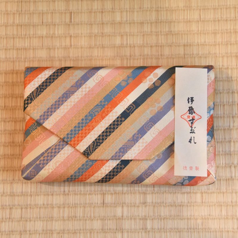 Decorative Sukiyabukuro with striped pattern and a label on a woven mat background