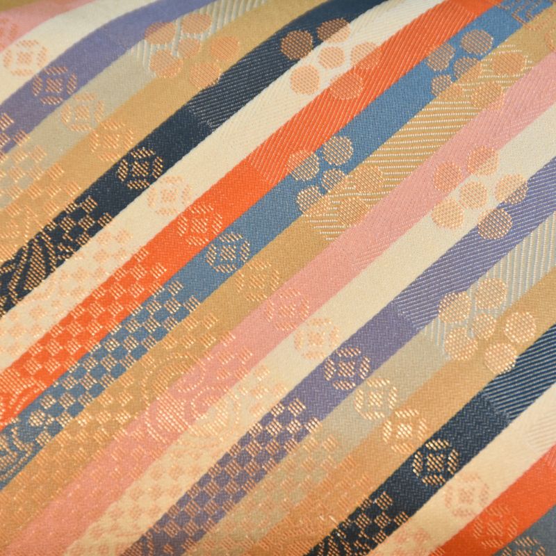 Striped fabric with a pattern of orange, blue, and beige colors.