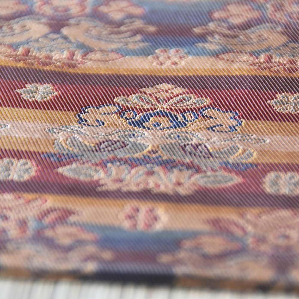 Close-up of patterned fabric with floral design on a grid background