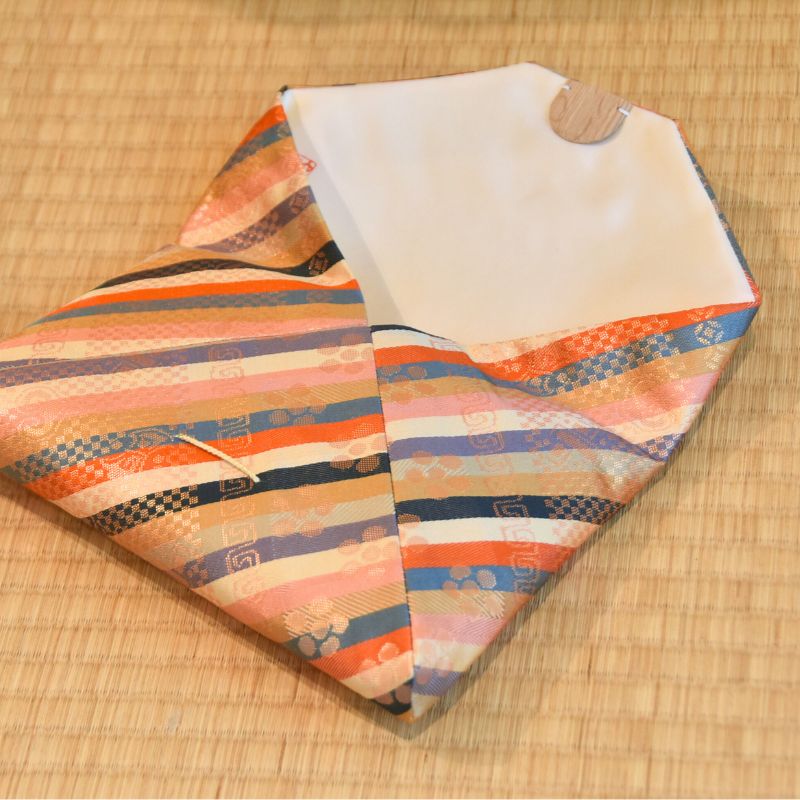 Colorful striped fabric on a wooden surface