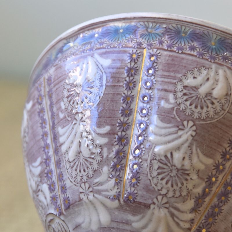 Decorative ceramic bowl with intricate floral patterns and gold accents