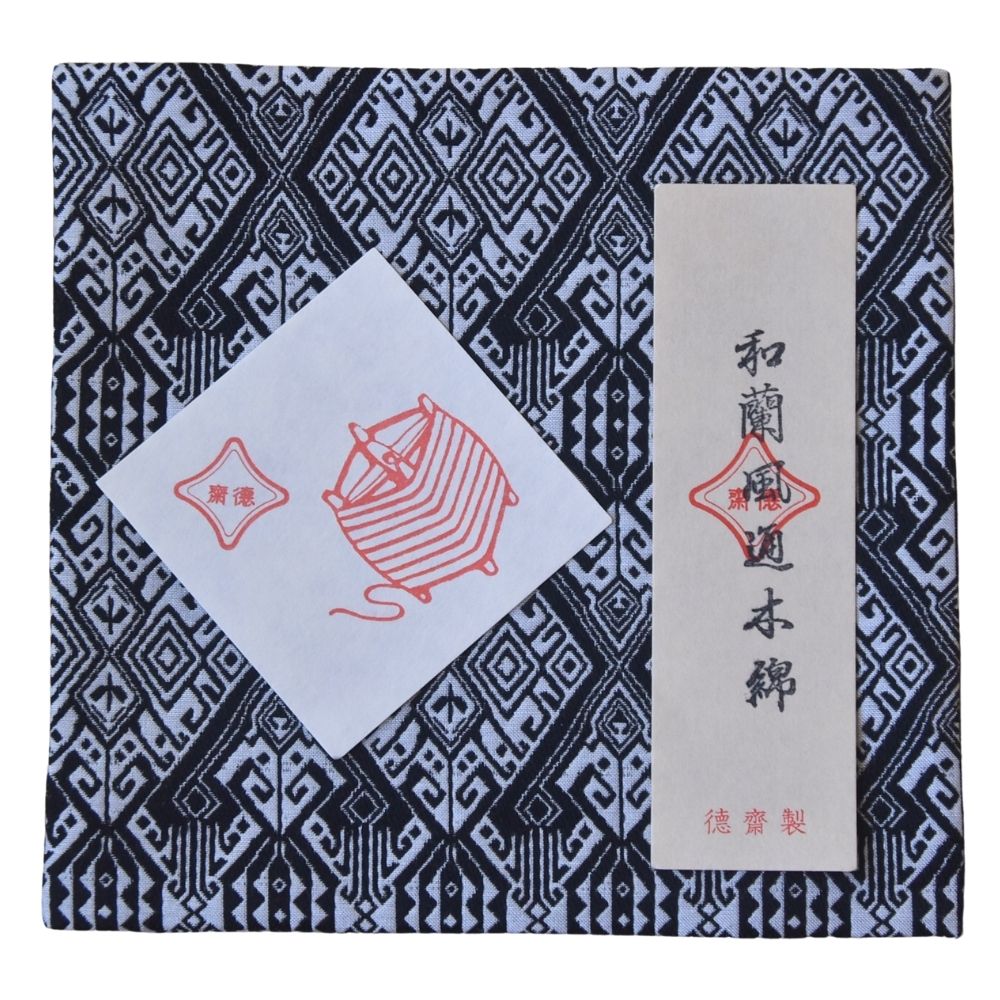 Product packaging with geometric pattern and red and white design elements on a blue and black background