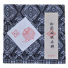 Product packaging with geometric pattern and red and white design elements on a blue and black background