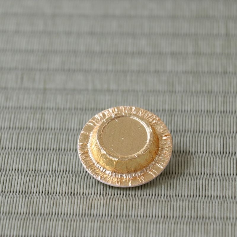 Back of a gold-colored Lacto resin lid for a Japanese tea caddy