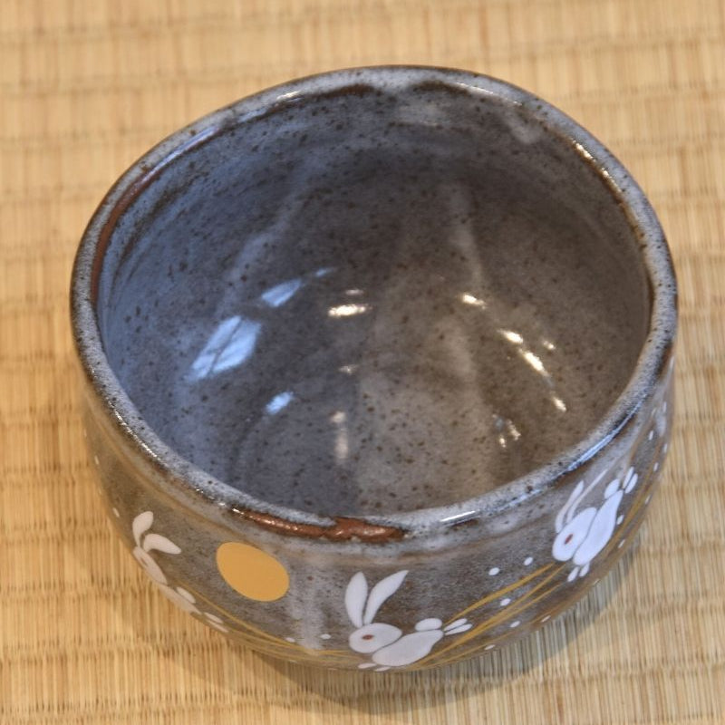 Top-down view of a matcha bowl showing a rabbit and the moon design.