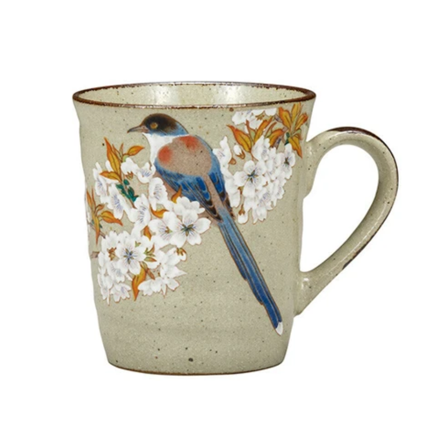 Mug with bird and floral design on a beige background