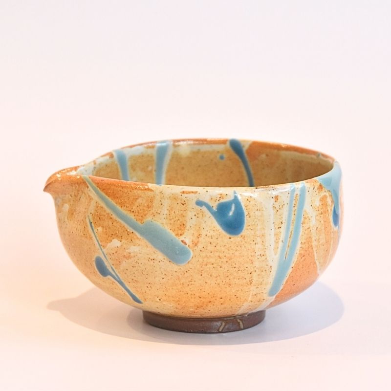 Ceramic bowl with blue abstract patterns on a beige background