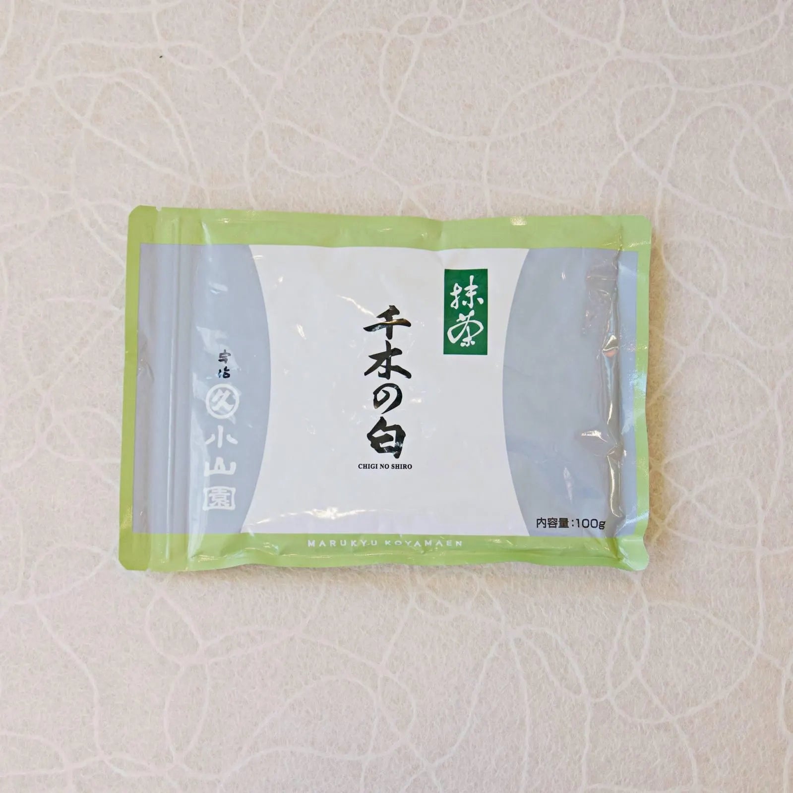 A canister of Chiginoshiro Matcha powder, with Japanese characters displayed on the label.