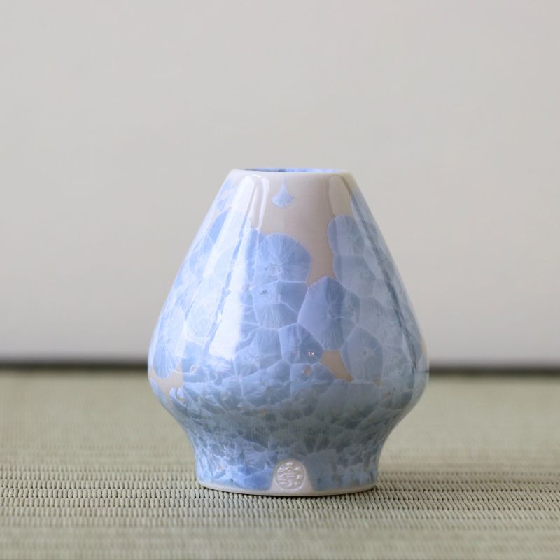 Matcha Whisk stand with blue and white cracked pattern on a neutral background