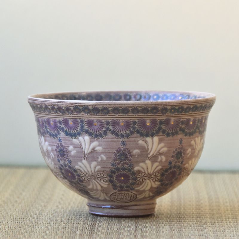 Decorative ceramic bowl with floral patterns on a neutral background