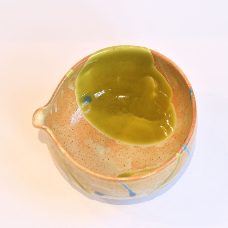 Ceramic bowl with a green interior on a white background