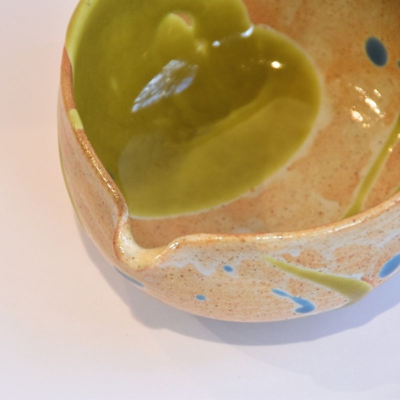 Ceramic bowl with a green interior on a white background